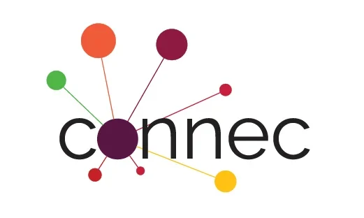 Eine Wissenschaftlerin und ein Wissenschaftler arbeiten hinter einer Glasfassade und mischen Chemikalien mit Großgeräten.