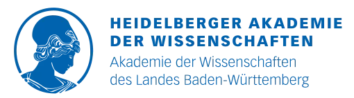 Eine Wissenschaftlerin und ein Wissenschaftler arbeiten hinter einer Glasfassade und mischen Chemikalien mit Großgeräten.