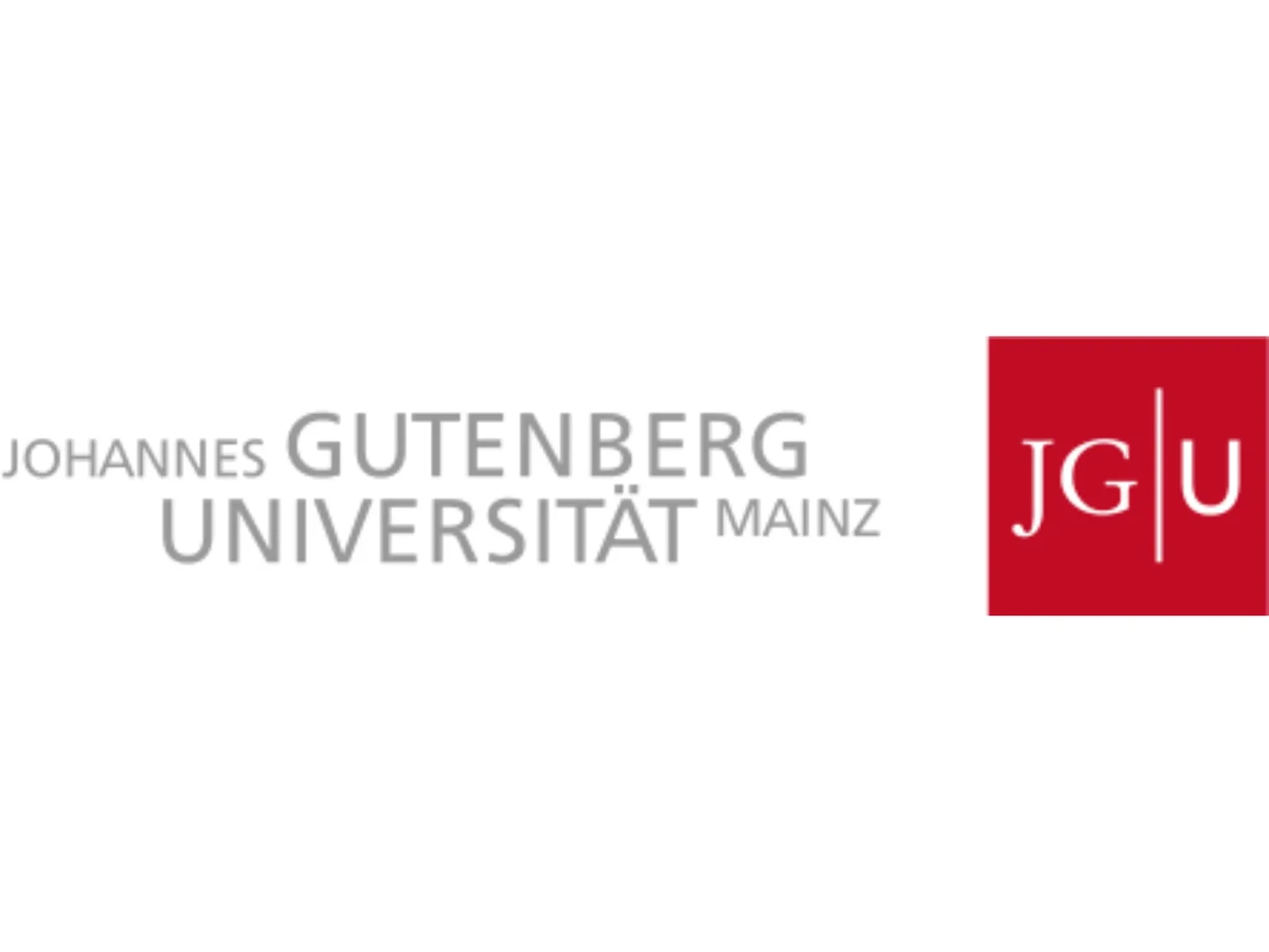 Eine Wissenschaftlerin und ein Wissenschaftler arbeiten hinter einer Glasfassade und mischen Chemikalien mit Großgeräten.